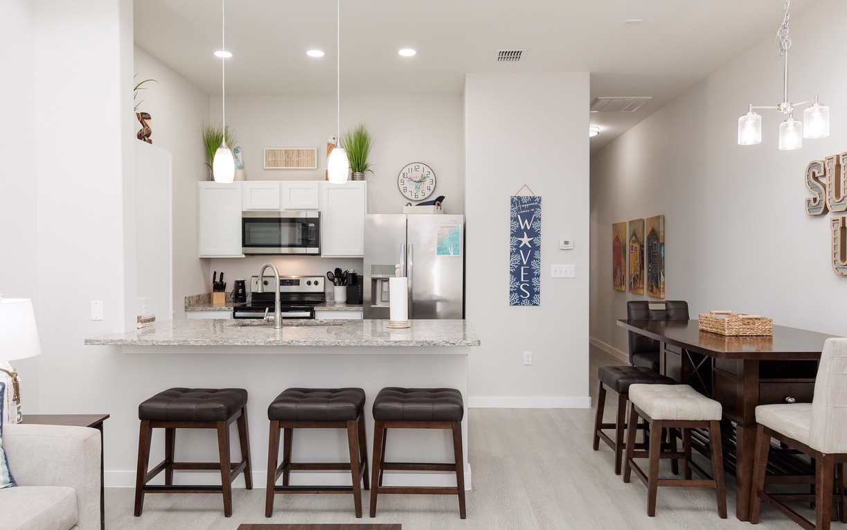 Step into your modern open-concept space where the sleek kitchen flows seamlessly into your dining area, perfect for morning coffee or evening meals.