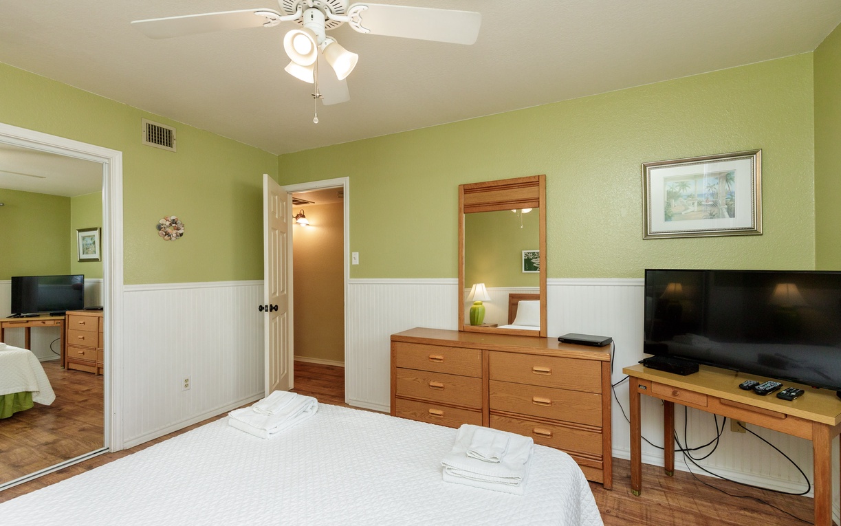 Settle into your peaceful bedroom with warm green walls, comfortable furnishings, and thoughtful touches that make this space feel like home.
