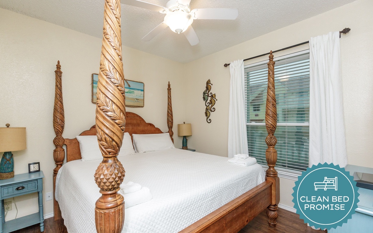 Unwind in your tropical-inspired bedroom with ornate four-poster bed and coastal touches creating a serene island escape.