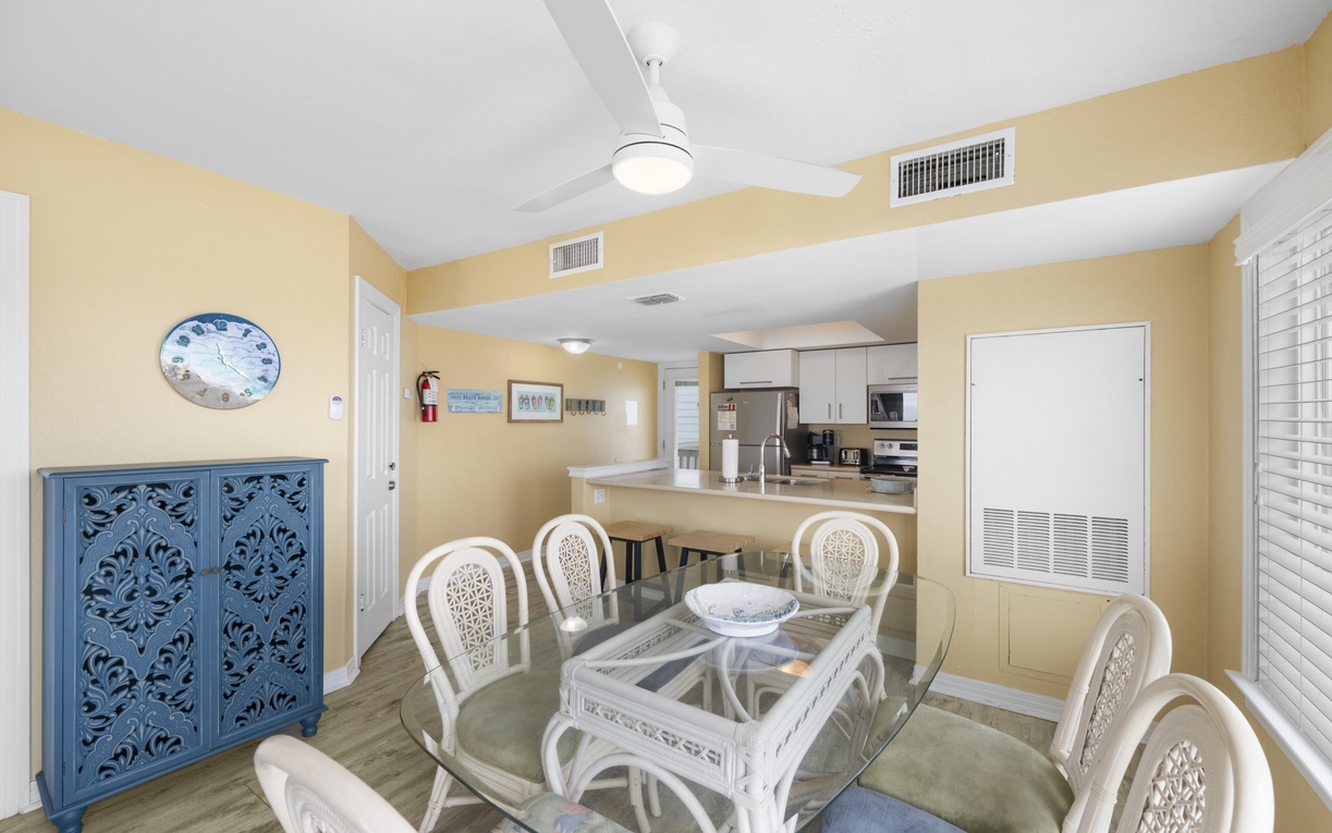 Your spacious dining area flows into the modern kitchen, where you'll prepare meals while enjoying peaceful natural views through floor-to-ceiling windows.