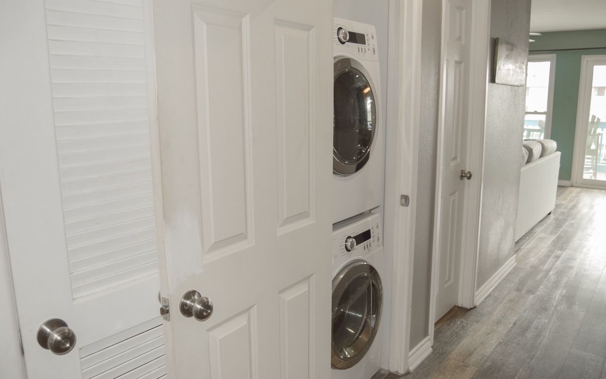 Your in-unit washer and dryer are conveniently tucked into this hallway alcove, making laundry day effortless during your stay.