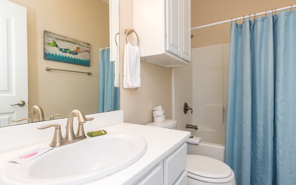 Your bright, well-appointed bathroom features a spacious vanity and refreshing shower where you can unwind after coastal adventures.