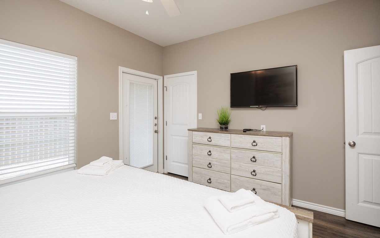 Your primary bedroom features a king size bed, ensuite bathroom, and patio access.