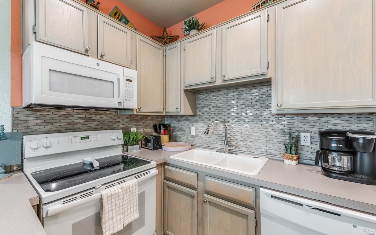 Cook your favorite meals in this fully equipped kitchen with modern appliances and charming tile backsplash.