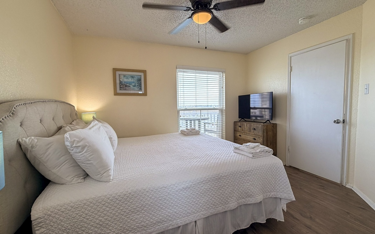 Drift off to peaceful dreams in your serene bedroom, complete with plush bedding, gentle ceiling fan breeze, and morning light filtering through.