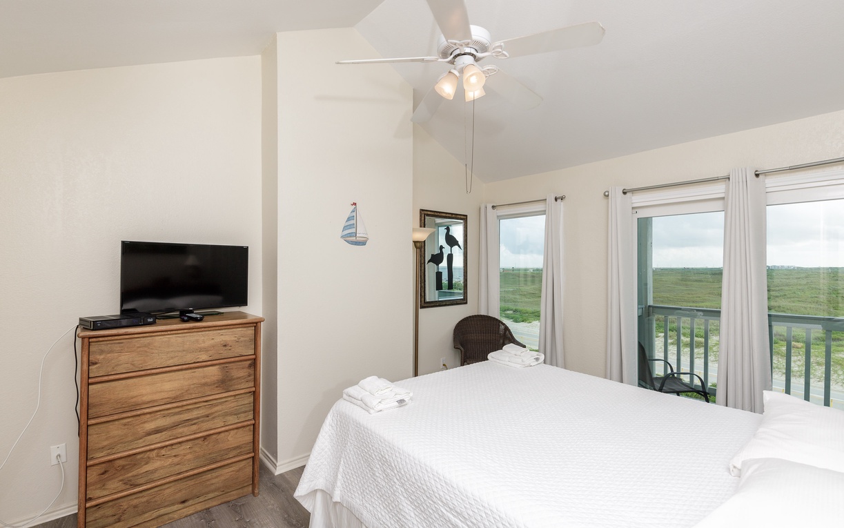 Relax in your peaceful bedroom with sweeping natural views, where crisp linens and coastal breezes create the perfect retreat.
