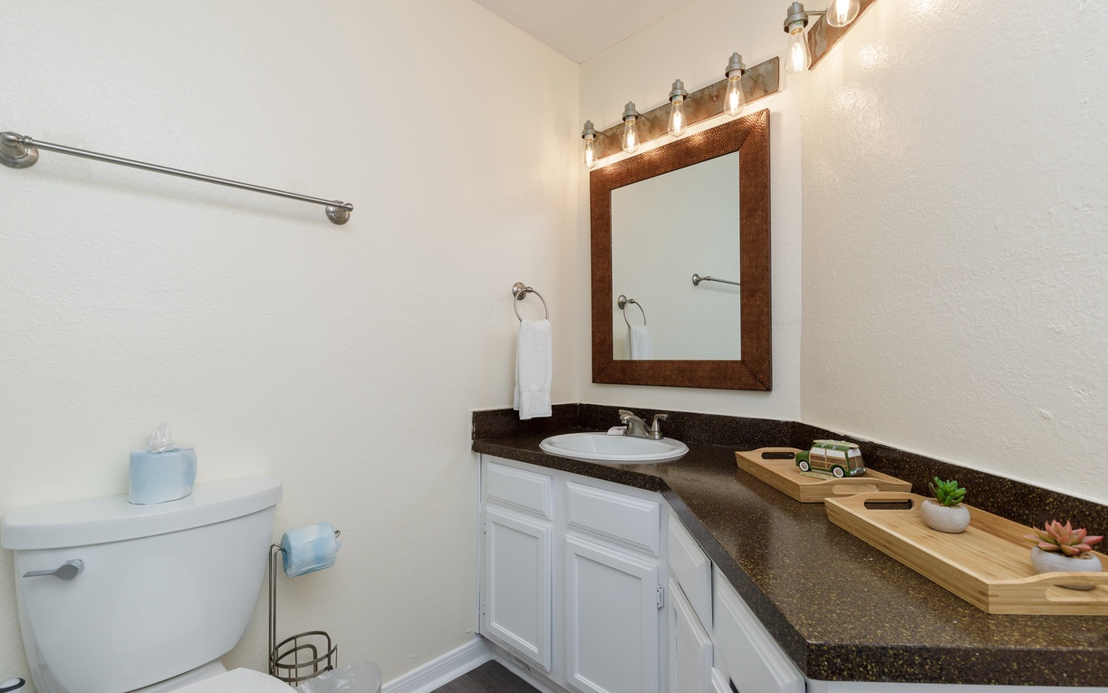 Your spacious bathroom features granite counters, warm lighting, and thoughtful touches that make your morning routine feel luxurious.