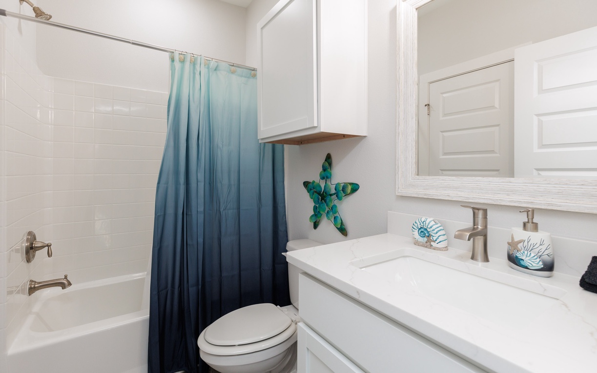 Freshen up in your pristine bathroom, featuring ocean-inspired décor and thoughtful touches that make your stay feel like home.
