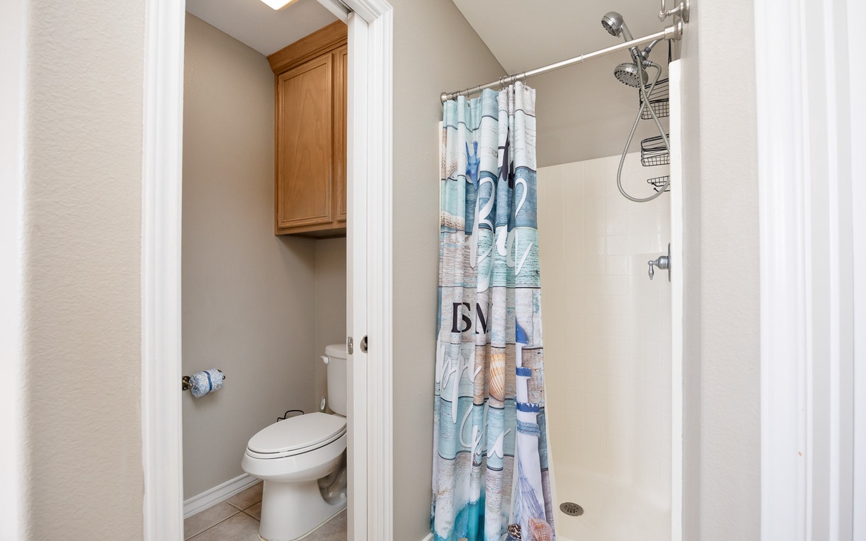 Your private bathroom features a refreshing walk-in shower with ocean-themed touches that bring coastal charm to your daily routine.