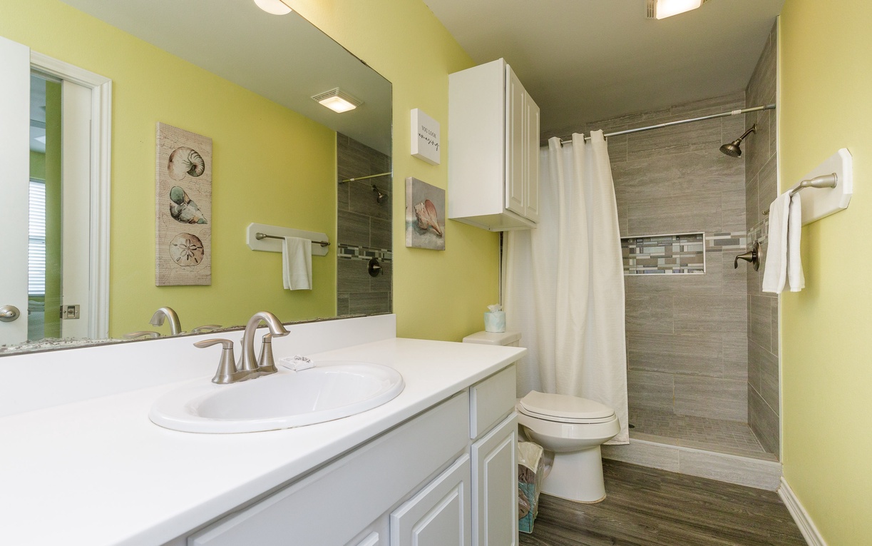 Refresh in your bright, cheerful bathroom with a spacious tiled shower and all the amenities you need.