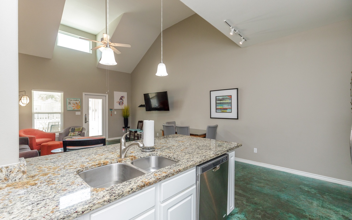 Your bright open kitchen flows seamlessly into the living space, with granite counters and modern appliances ready for your vacation cooking adventures.