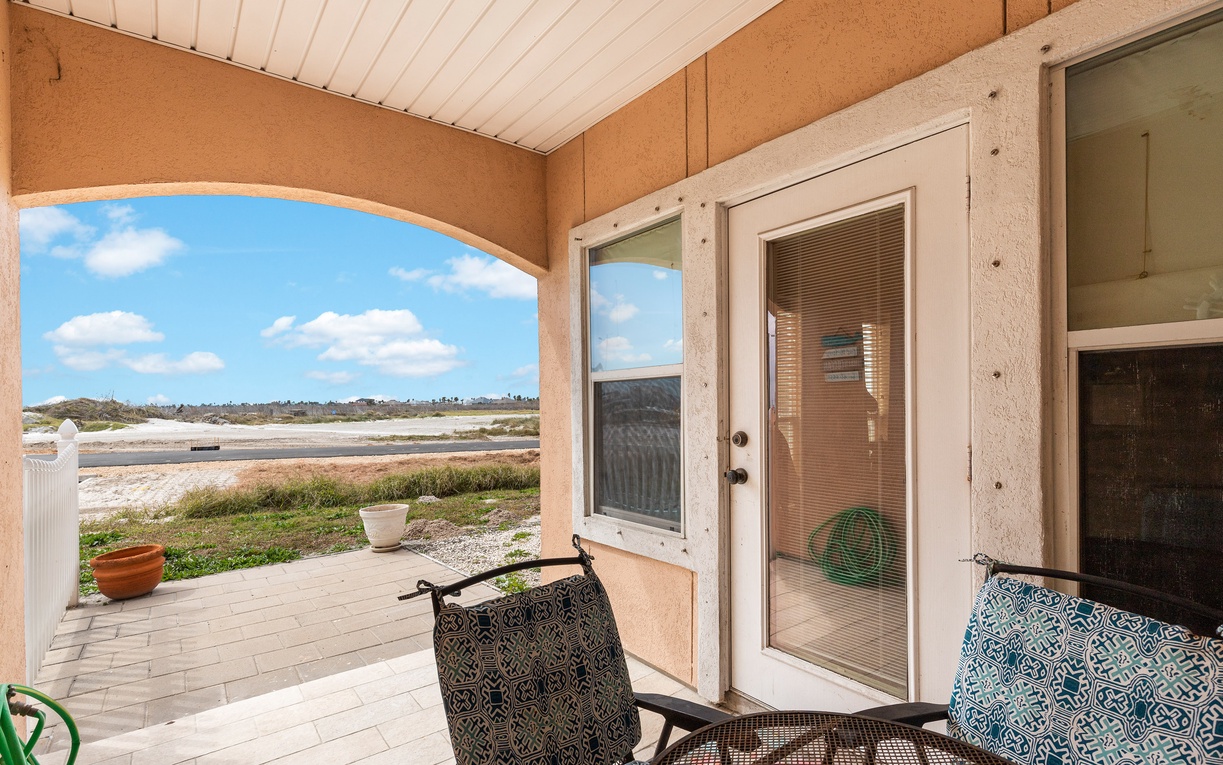 Unwind on your private covered patio, where comfortable seating overlooks peaceful coastal views and endless blue skies.