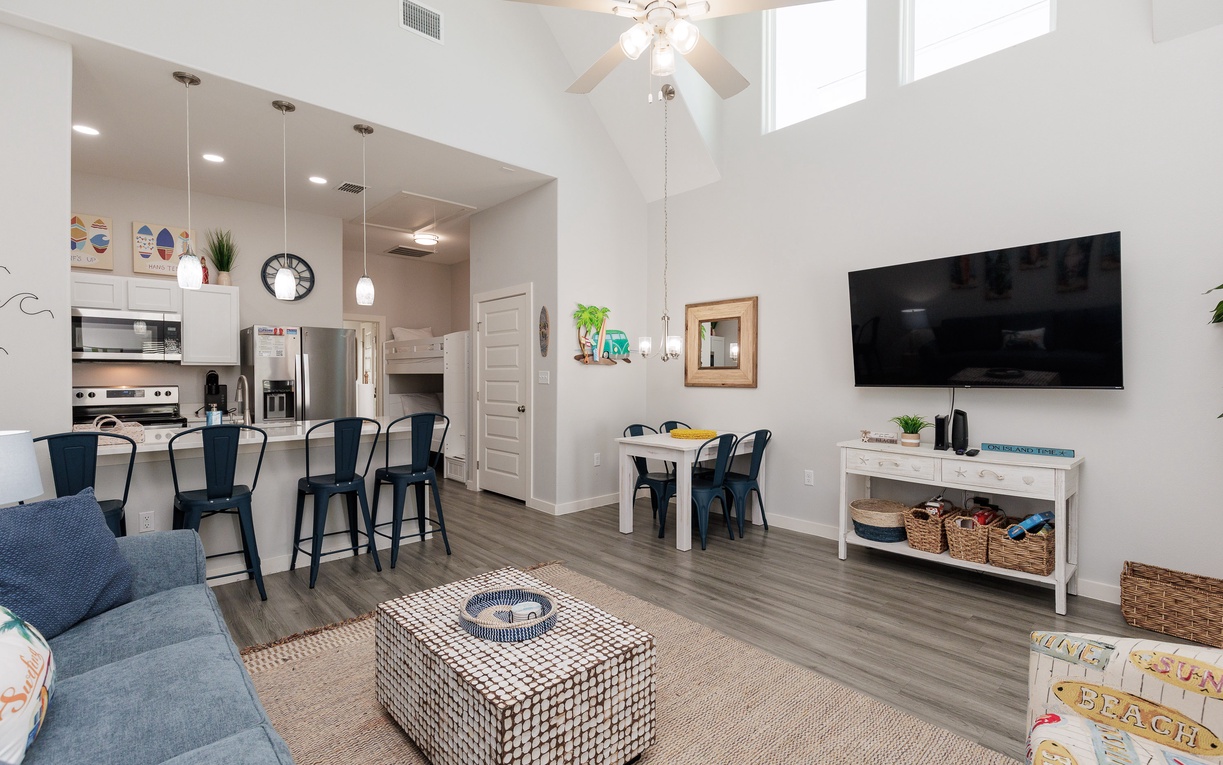 Unwind in your bright, open-plan living space with soaring ceilings, modern kitchen, and comfortable seating perfect for relaxing together.
