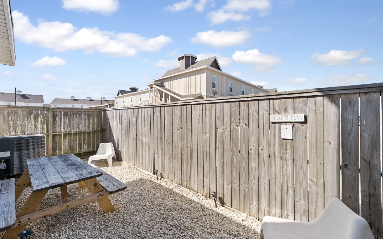 Your private backyard oasis awaits with a cozy picnic table where you can enjoy morning coffee or evening meals under open skies.