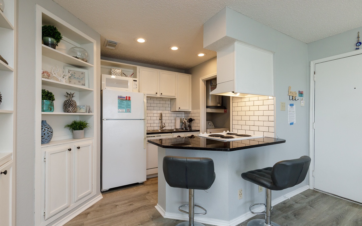 Your fully equipped kitchen features granite counters, breakfast bar seating, and everything needed for cooking memorable meals.