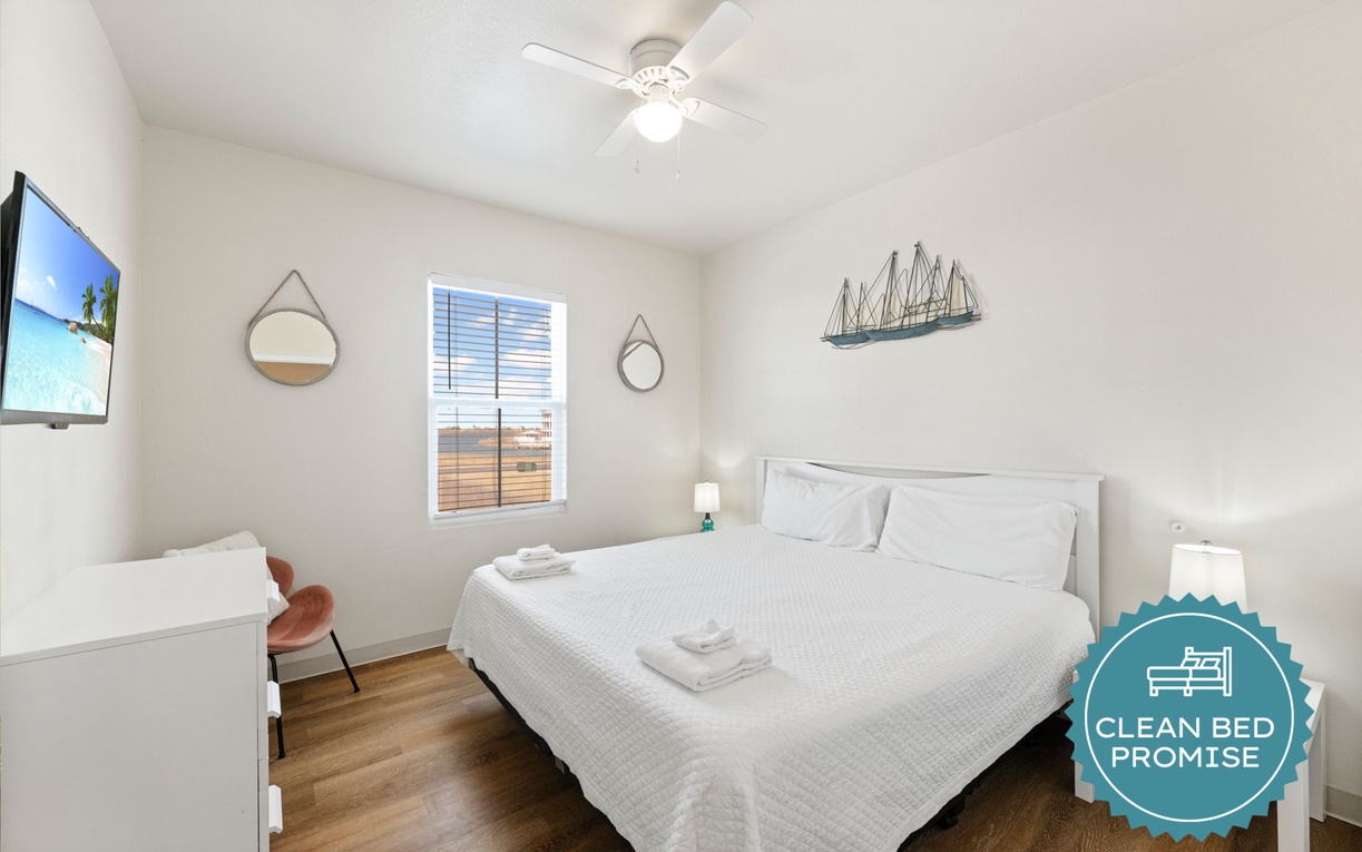 Rest peacefully in your bright bedroom with crisp linens, nautical touches, and a cooling ceiling fan overhead.