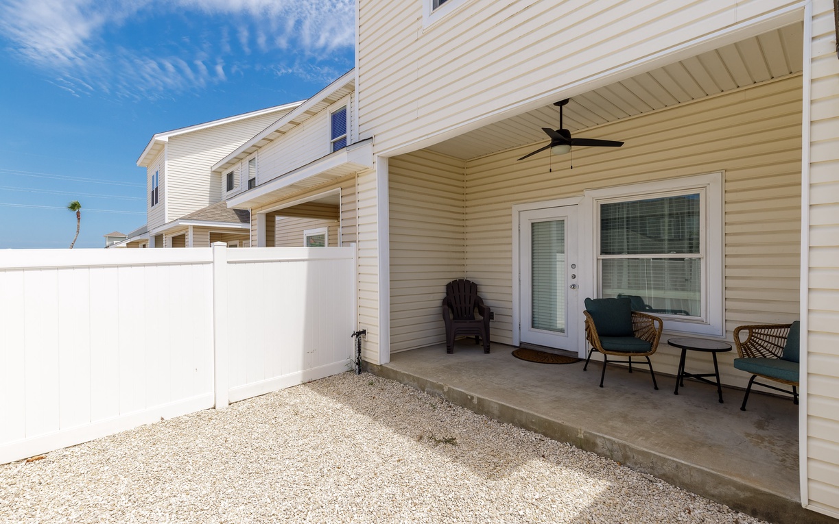 Relax on your private covered patio with comfortable seating and ceiling fan, perfect for morning coffee or evening conversations.