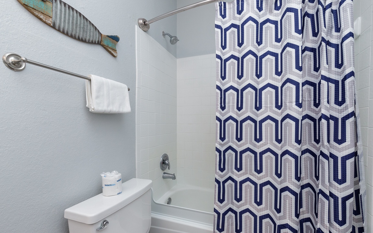 Fresh towels and nautical décor create a relaxing coastal vibe in your private bathroom with tub-shower combo.
