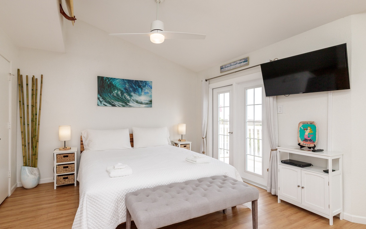 Unwind in your serene bedroom featuring crisp white linens on the king size bed