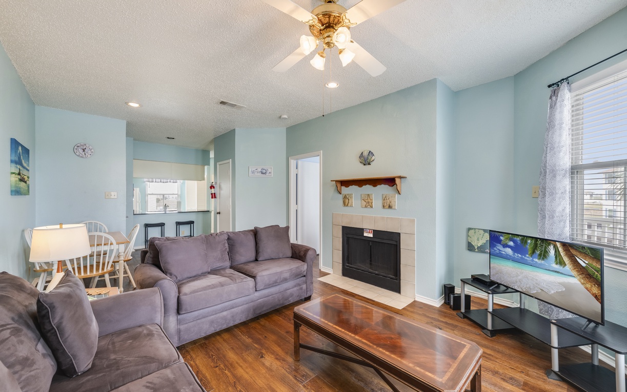 Spacious living room with a large TV, and comfortable sofas—an inviting space for movie nights and quality time together.