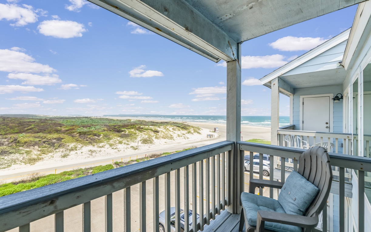The beachfront property sits directly on sandy shores, offering sweeping coastal views where natural dunes meet the ocean and sky. Ideal for a seaside escape.