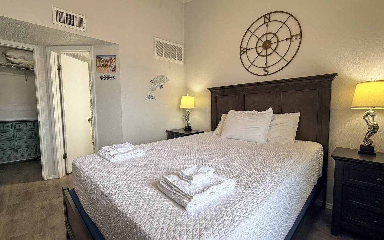 Your comfortable bedroom features a plush bed with crisp linens, nautical touches, and warm lighting for the perfect night's rest.