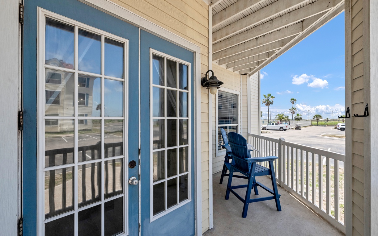 Step onto your private balcony and settle into the blue chair for morning coffee with views of palm-lined streets.