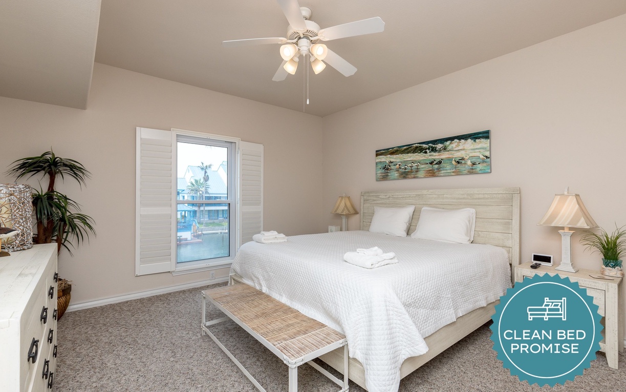 Drift off in your coastal sanctuary with crisp white linens and gentle ceiling fan breezes flowing through bright windows.