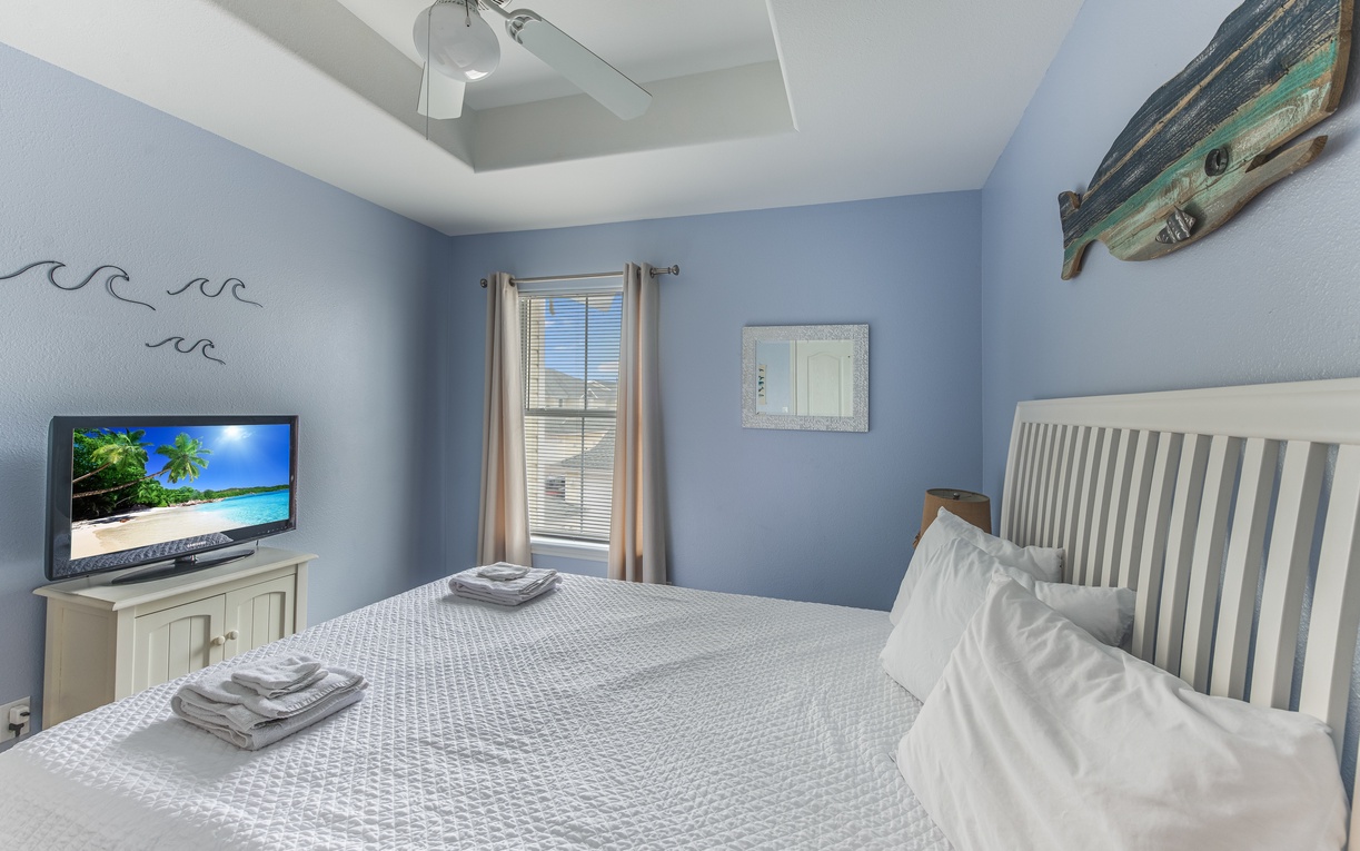 Drift off in this serene coastal bedroom where ocean-blue walls and nautical touches create your perfect seaside retreat.