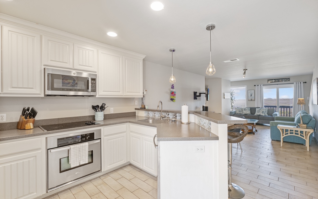 Your spacious kitchen flows seamlessly into the living area, perfect for cooking and entertaining with modern appliances and stunning views.