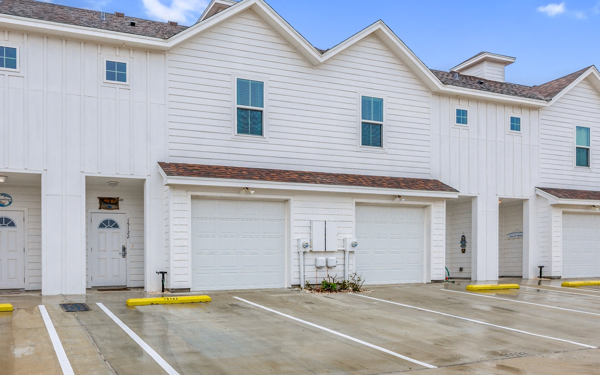 Modern townhome complex with convenient parking spaces directly at your unit's entrance for easy arrival.
