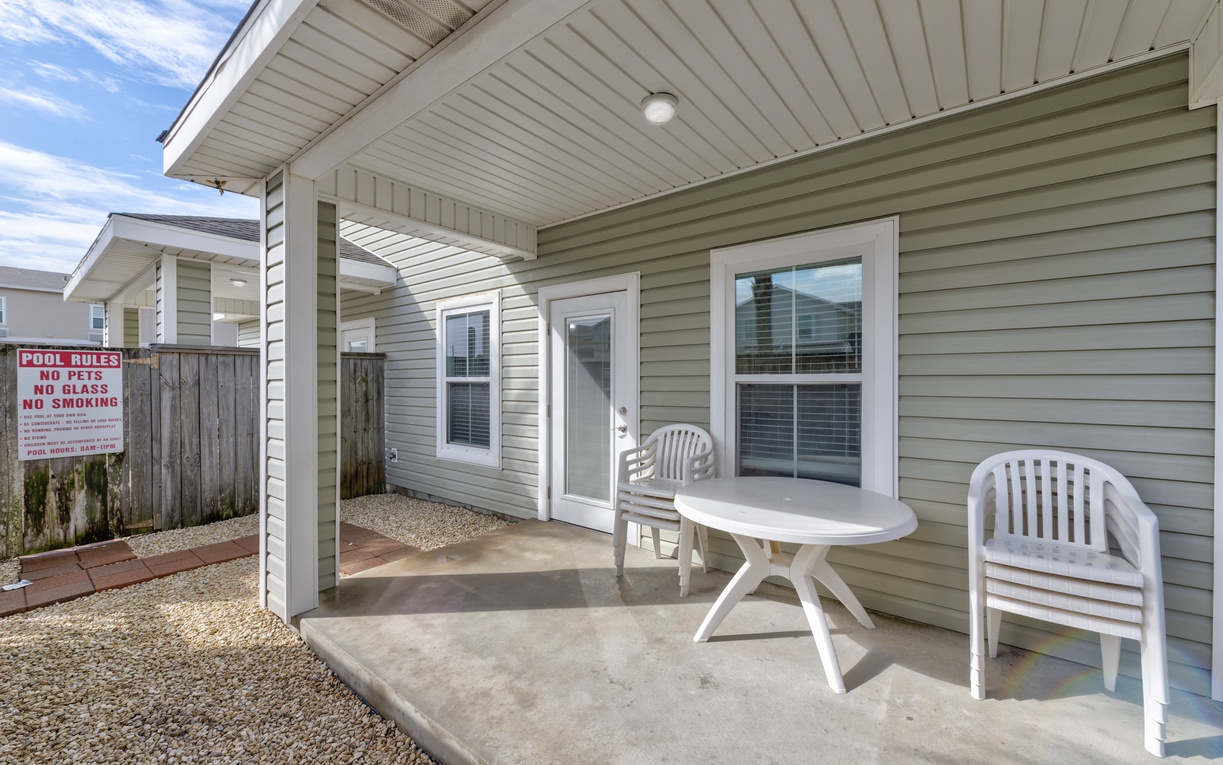 Relax on your private covered patio with comfortable seating while enjoying fresh air and peaceful moments between beach adventures.