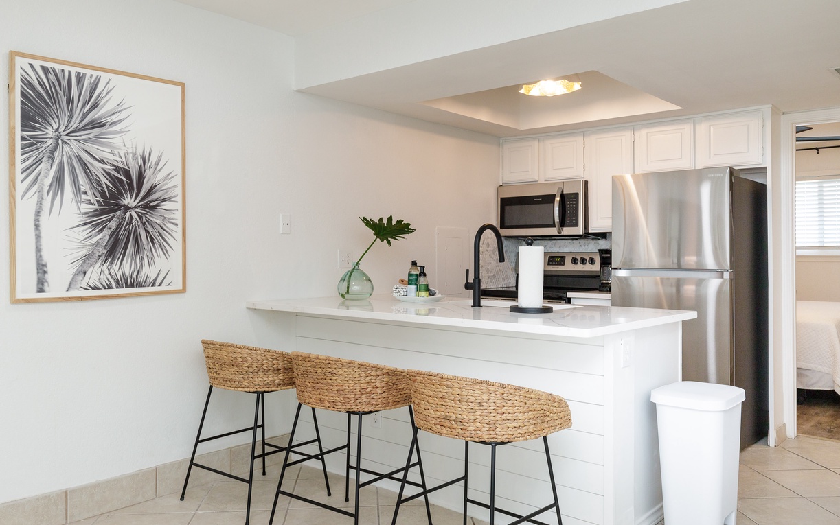 Your fully equipped kitchen features stainless steel appliances and a breakfast bar where you can start each morning with coffee.