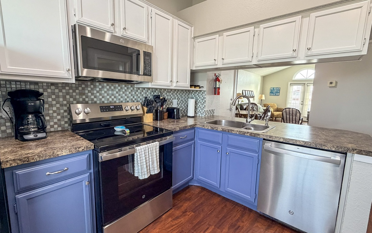 Cook memorable meals in your fully-equipped kitchen with granite counters, stainless appliances, and charming blue cabinets.