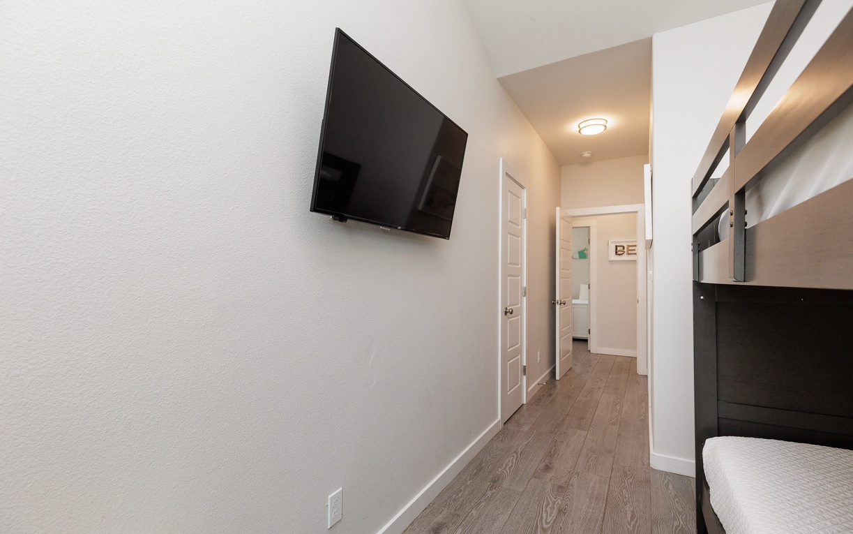 Unwind in your modern retreat with a flat-screen TV and sleek bunk beds, perfectly designed for comfort and convenience.
