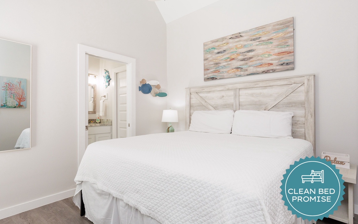 Drift off in coastal comfort with crisp white linens and soothing ocean-inspired artwork creating your perfect seaside retreat.