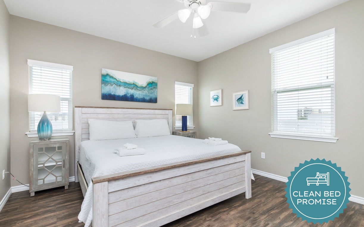 Drift off to restful sleep in your bright, airy bedroom featuring coastal-inspired decor and crisp linens.