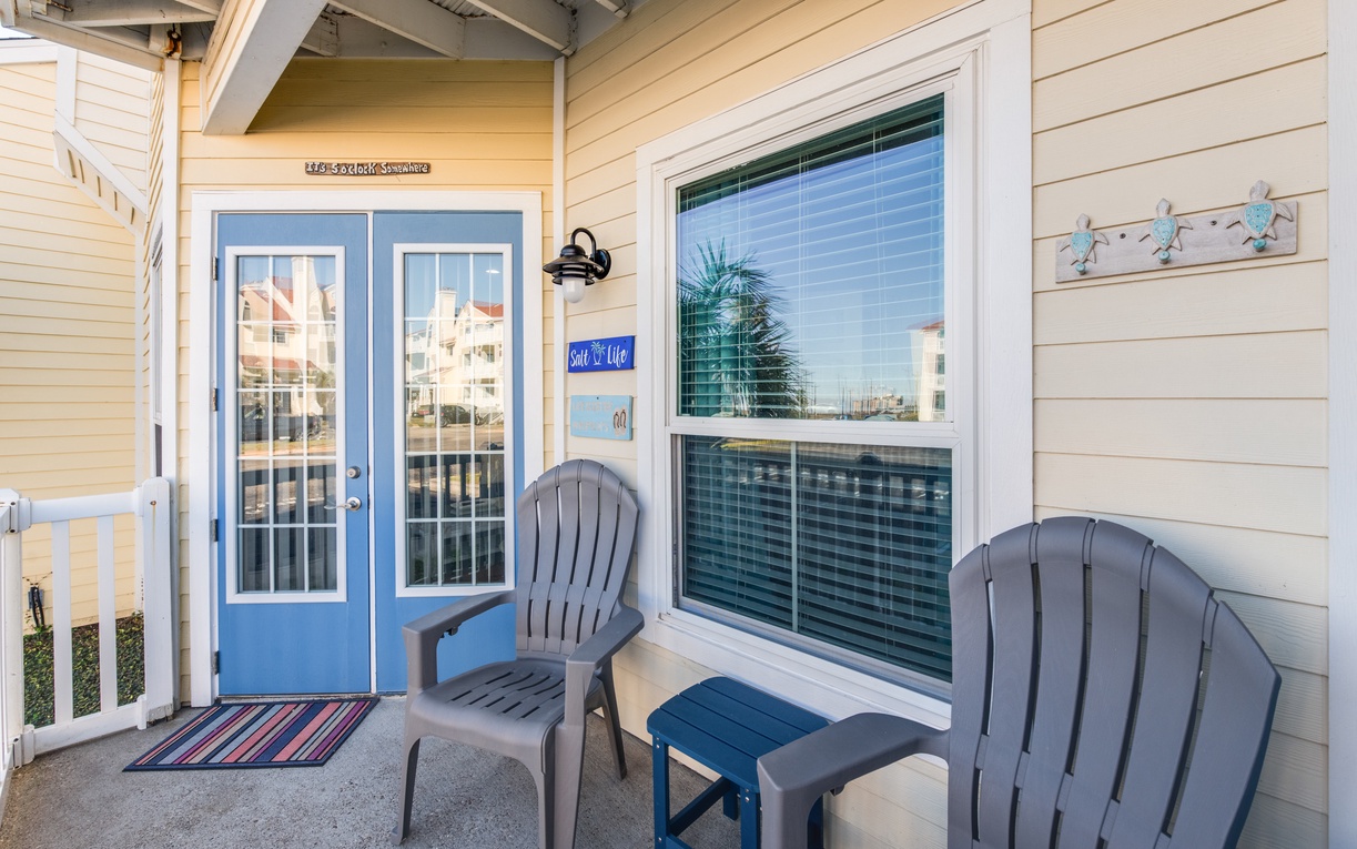 Relax on your private balcony with comfortable Adirondack chairs and charming coastal decor, perfect for morning coffee or evening unwinding.