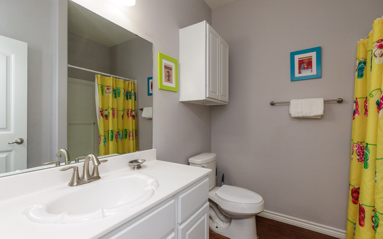 Your bright bathroom features cheerful beach-themed décor, a spacious vanity, and everything you need for a refreshing start to your day.