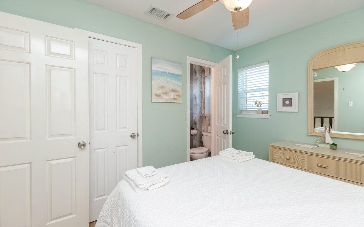 Your second bedroom sanctuary features calming mint walls, crisp queen linens, and gentle ceiling fan breezes for restful nights.