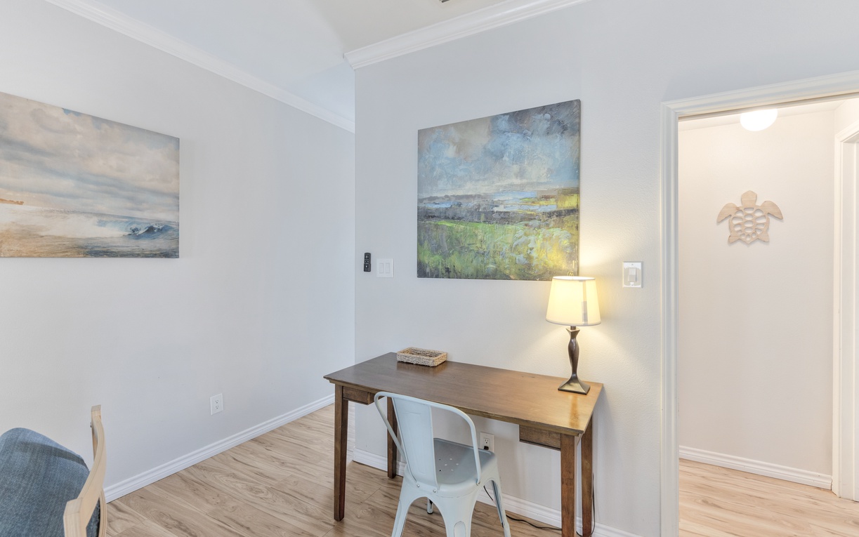 Your dedicated workspace features a stylish desk, comfortable seating, and inspiring artwork to fuel your creativity.