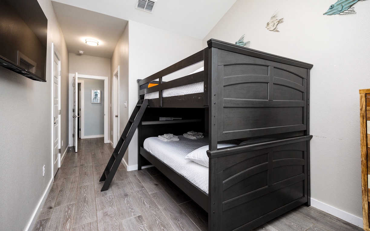 Your kids will love this stylish bunk bed setup with whimsical sea creature art creating the perfect adventure-themed bedroom space.