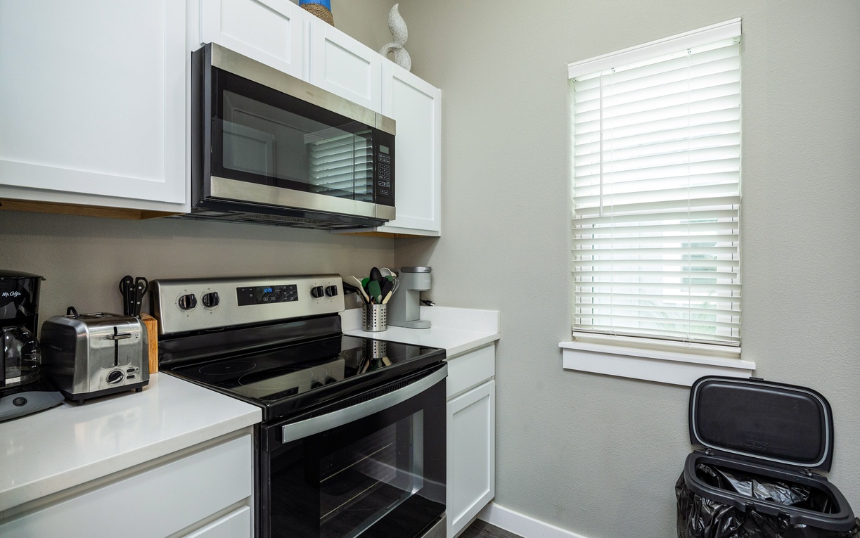 Your fully equipped kitchen features modern appliances and bright natural light, perfect for preparing meals during your stay.