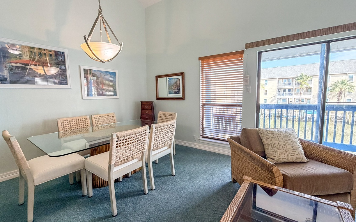 Unwind in your bright dining space with coastal-inspired furnishings and large windows that flood the room with natural light.