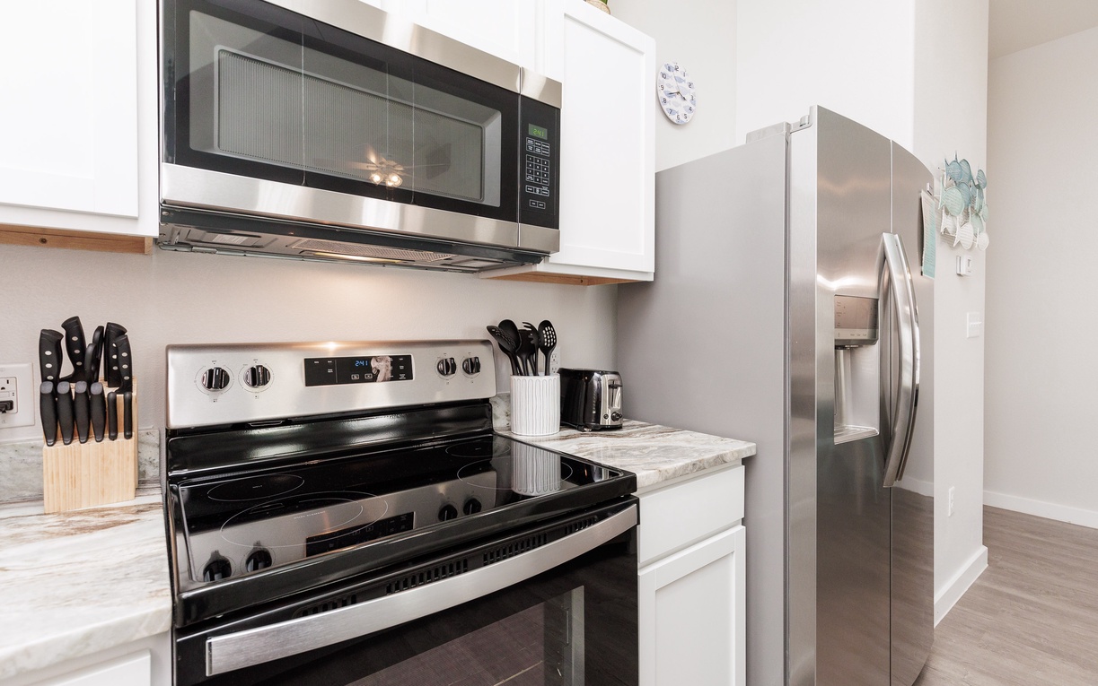 Your fully equipped kitchen features stainless steel appliances and marble countertops, perfect for preparing memorable meals during your stay.