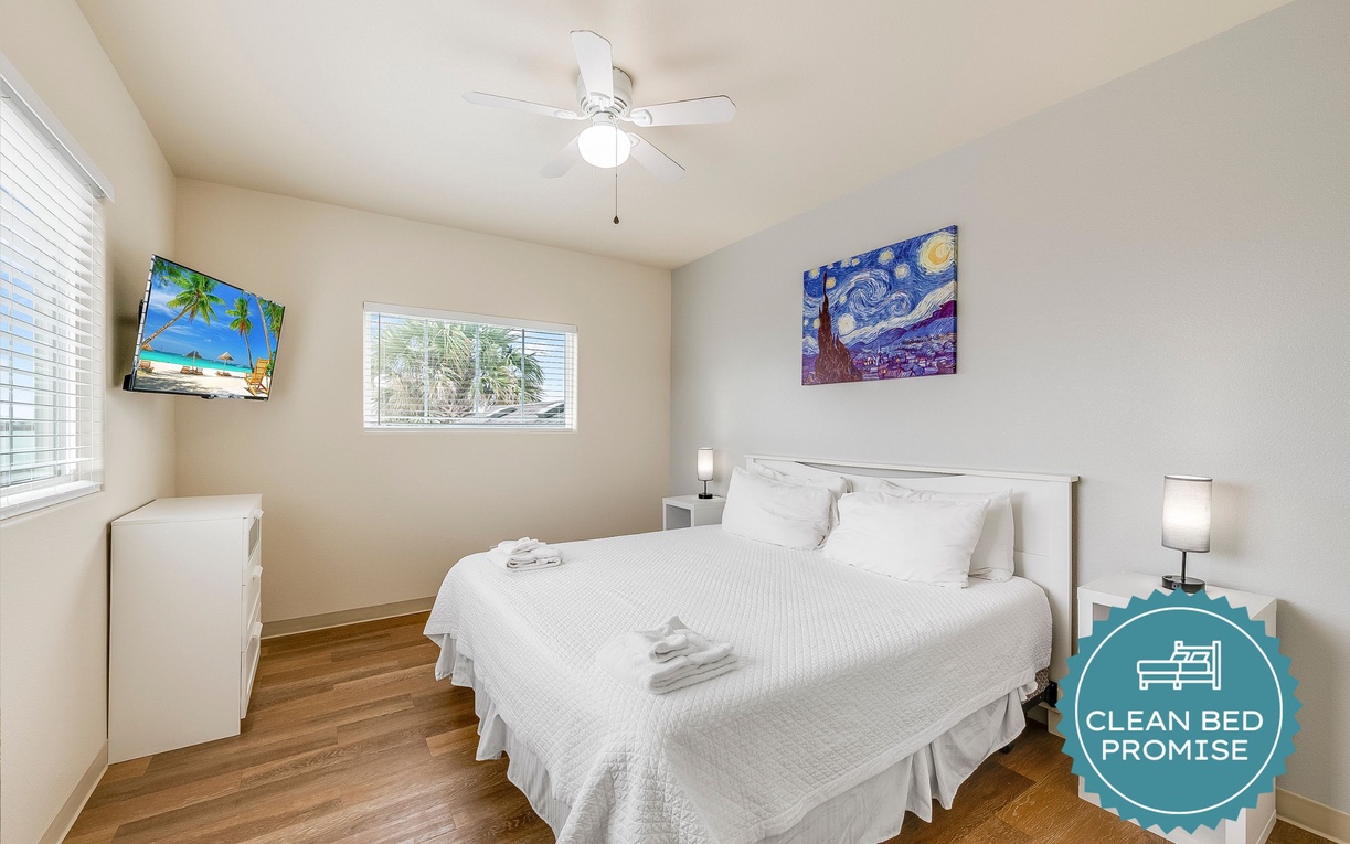 Unwind in your bright, clean bedroom with crisp linens and tropical art that sets a relaxing vacation mood.