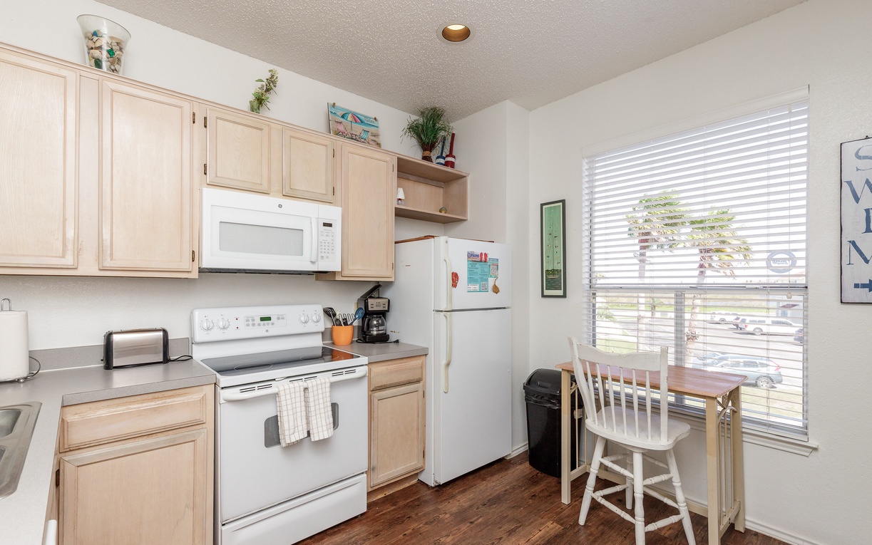 Your fully equipped kitchen features everything you need to whip up meals, from morning coffee to family dinners, with natural light streaming in.