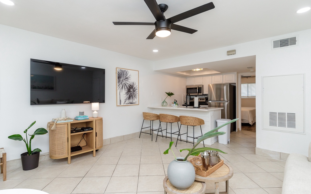 Relax in your bright, modern living space with coastal-inspired décor, full kitchen, and stylish furnishings for perfect vacation comfort.