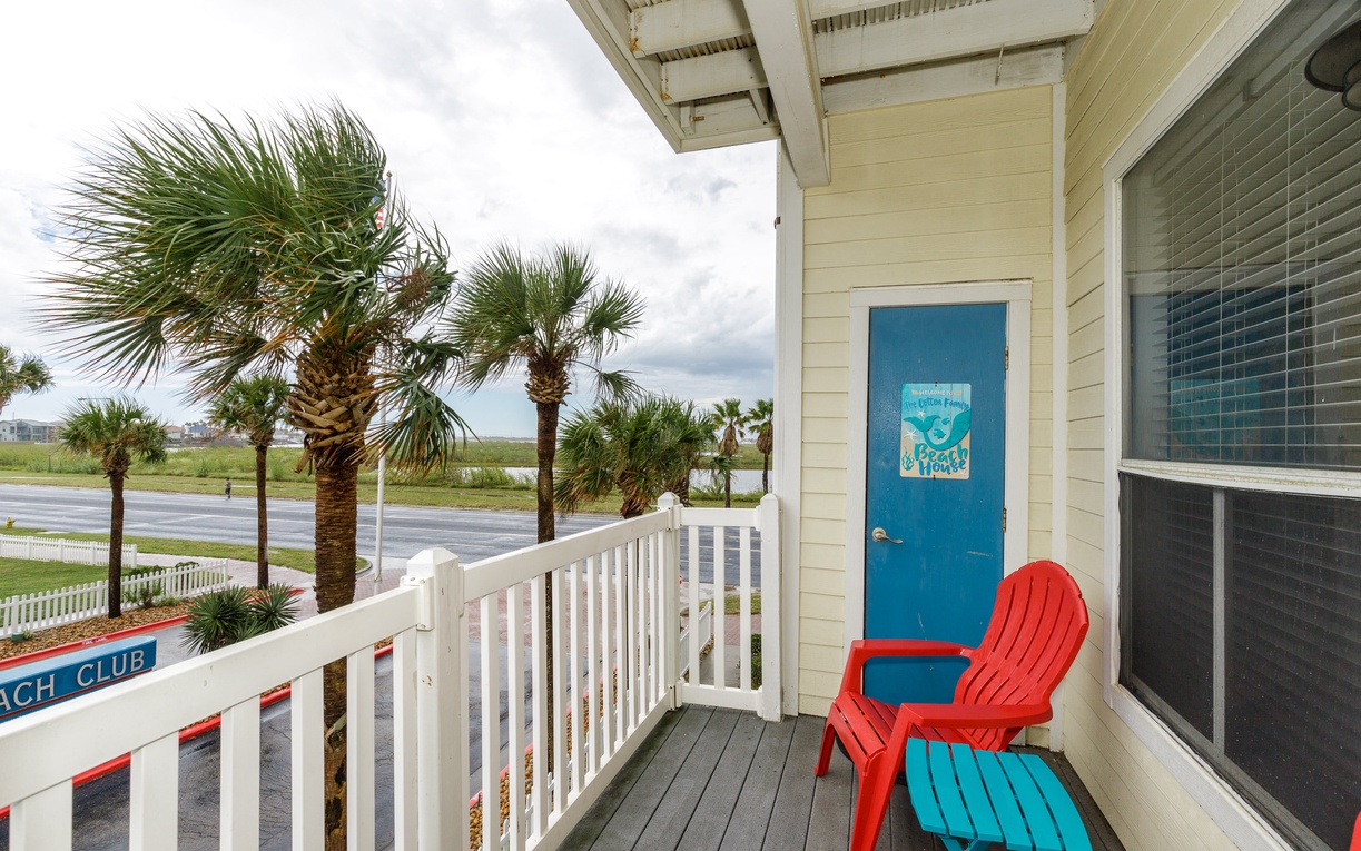 Your private balcony offers colorful seating with tropical palm views and coastal breezes for perfect morning coffee moments.