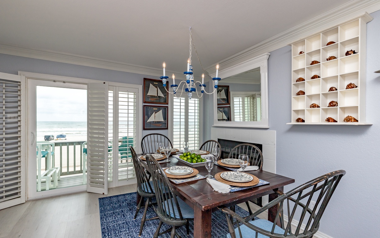Gather around your elegant dining table with stunning ocean views through plantation shutters and nautical touches throughout.